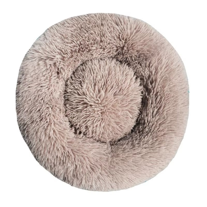 Round fluffy pet bed on a white background